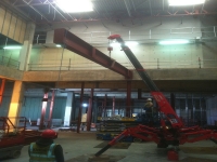 Mini Spider Crane erecting steel in a building with an electric powered crane.