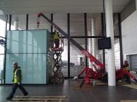 Mini Crane installing glass in a building in Dublin's IFSC centre.