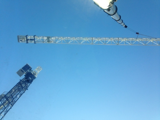 Mobile crane erecting a tower crane in Dublin.